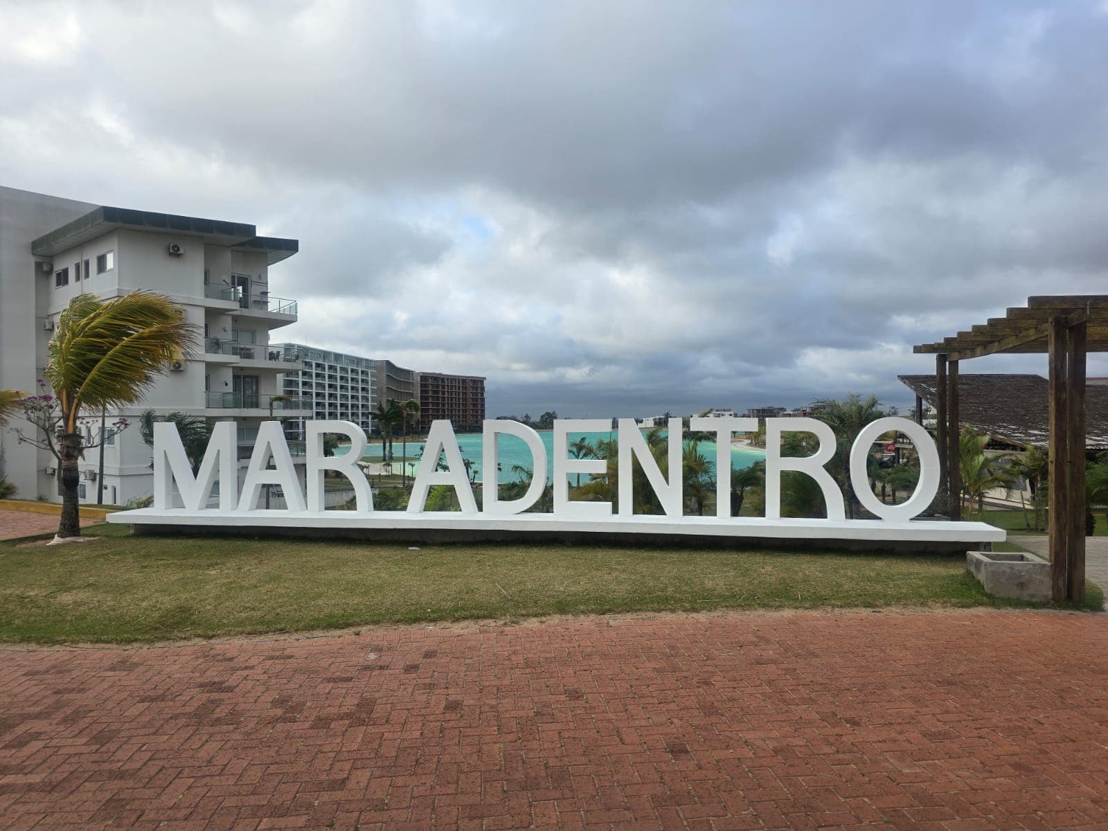 The Mar Adentro entrance sign and its communal artificial lagoon — the resort-style development where Davezies House is located