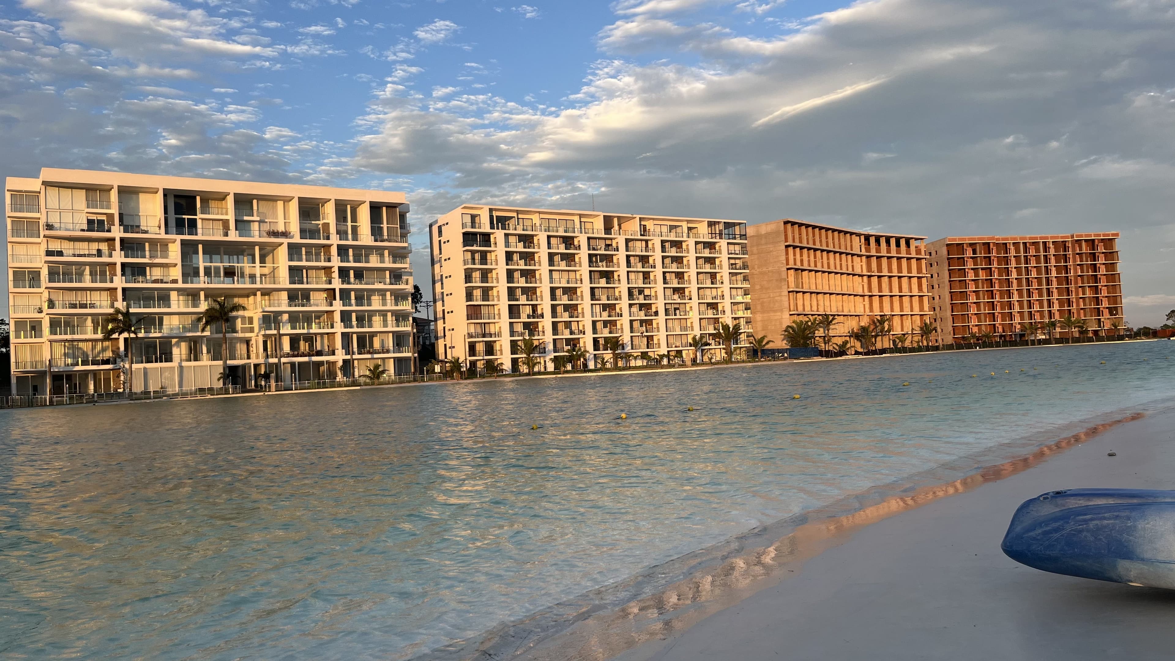 The Mar Adentro communal lagoon and beach up close — the same body of water glimpsed behind the entrance sign